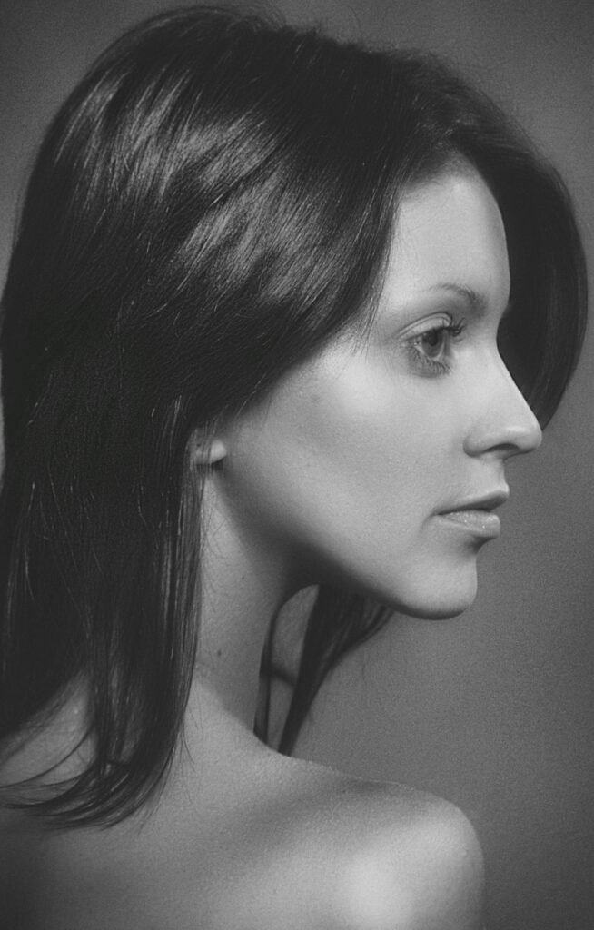 Black and white profile portrait of a woman with strong features and graceful posture.
